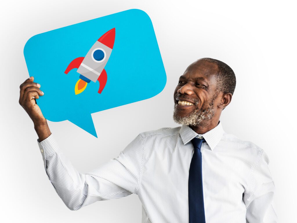 A man holing up an image of a rocket ship